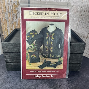 May include: A sewing pattern for a jacket, mittens, hat, and purse. The pattern is called "Decked in Holly" and is by Cathy Pendleton. The pattern number is 11687. The pattern is from Indygo Junction, Inc.