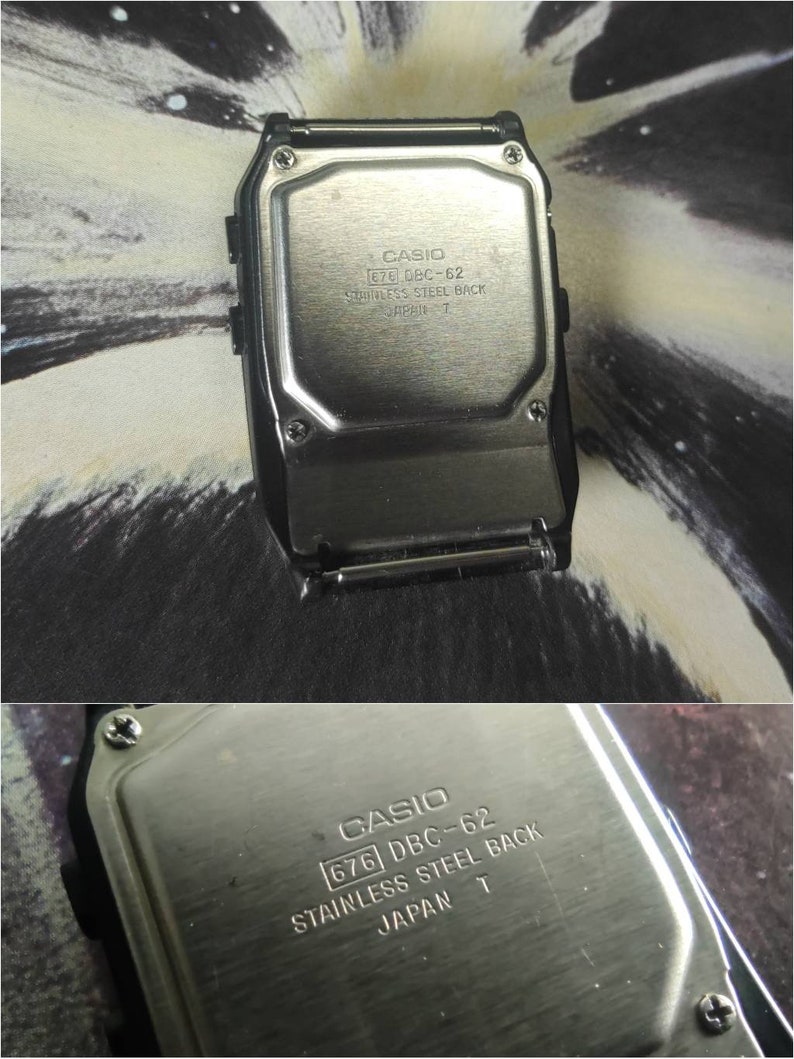 May include: The back of a silver Casio watch with the text "CASIO 676 DBC-62 STAINLESS STEEL BACK JAPAN T" engraved on it.