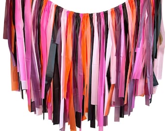 May include: A colorful tissue paper garland with pink, purple, orange, and black streamers. The garland is strung together with twine and is perfect for adding a festive touch to any party or event.
