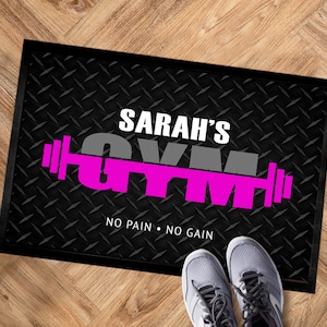 May include: Black doormat with a grey and pink "Sarah's Gym" design with a barbell graphic and the text "No Pain No Gain".