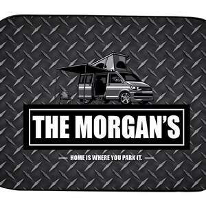 May include: Black and white illustration of a camper van with a pop-up roof and awning. The van is on a black and white diamond plate background. The text "THE MORGAN'S" is in a white rectangle with a black border. Below the rectangle is the text "HOME IS WHERE YOU PARK IT."