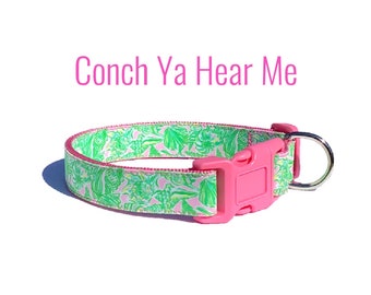 May include: Pink dog collar with a green and white floral print and the text "Conch Ya Hear Me".
