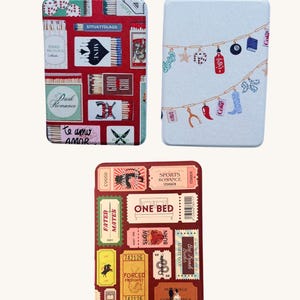 May include: Three rectangular cases with unique designs. One features matchboxes and the phrases "Dark Romance" and "Te amo amor." Another has a string of themed objects. The third case has ticket stubs with phrases like "One Bed" and "Fated Mates."