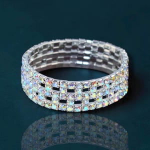 May include: A set of three ceramic mugs with a speckled, matte finish. The mugs are in shades of cream, light gray, and dark gray. Each mug has a simple, modern design and a rounded handle.