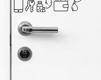 May include: A white door with a silver door handle and a silver deadbolt lock. There are several black line drawings of everyday items on the door, including a cell phone, keys, a bottle of pills, a clock, a wallet, and sunglasses.