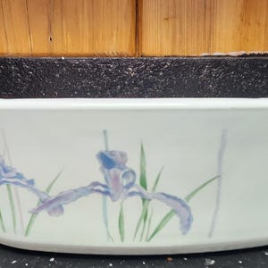 May include: White oval baking dish with a floral design featuring blue and purple irises on a white background.
