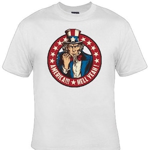 May include: White t-shirt with a red, white, and blue graphic of Uncle Sam with the text "America!!! Hell Yeah!"