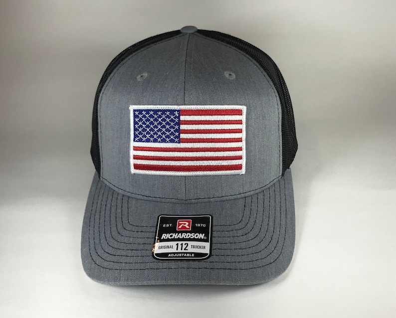 May include: Gray and black trucker hat with an American flag patch and the text "EST. 1970 RICHARDSON. ORIGINAL 112 TRUCKER ADJUSTABLE" on the front.