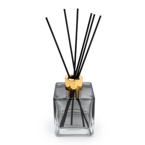 May include: A black glass diffuser bottle with a gold lid and black diffuser sticks.