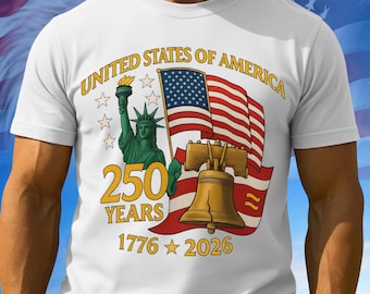 May include: White t-shirt featuring a patriotic design celebrating 250 years of the United States of America. The design includes the Statue of Liberty, a waving American flag, and the Liberty Bell, with the text "UNITED STATES OF AMERICA" and "250 YEARS 1776-2026".