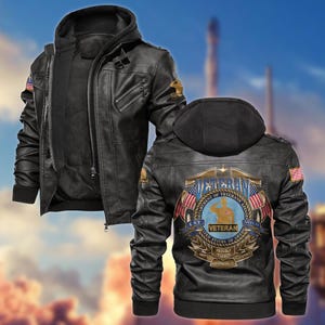 May include: Black leather jacket with a detachable hood. The jacket features a zipper closure, multiple pockets, and patches with the American flag and the word "Veteran". The back of the jacket displays a Veteran's Affairs emblem.