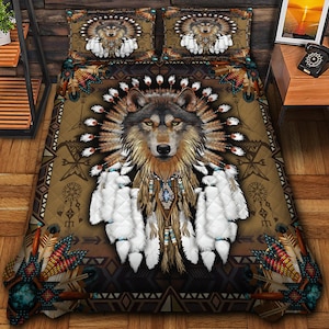May include: A brown and tan quilt set featuring a detailed wolf design with a feathered headdress and decorative accents. The set includes a quilt and two pillow shams, showcasing a Native American-inspired theme with geometric patterns and earthy tones.