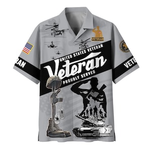 May include: A light gray short-sleeve button-down shirt featuring a black diagonal stripe with the text "UNITED STATES VETERAN" and "PROUDLY SERVED". The design includes military graphics, a soldier saluting, a tank, and a rifle with boots.