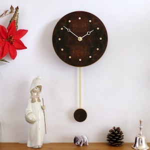 Handmade Wooden Wall Clock. Pendulum Wall Clock in quarter-matched burr walnut with inlaid sycamore dots. Small Circle Clock.