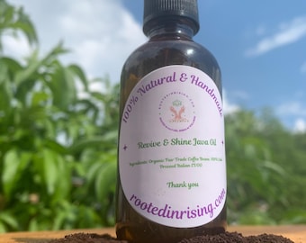 May include: A brown glass bottle with a dropper top and a white label that reads "100% Natural & Handmade Revive & Shine Java Oil Ingredients: Organic Fair Trade Coffee Beans, 100% Cold Pressed Italian EVOO Thank you rootedinrising.com"