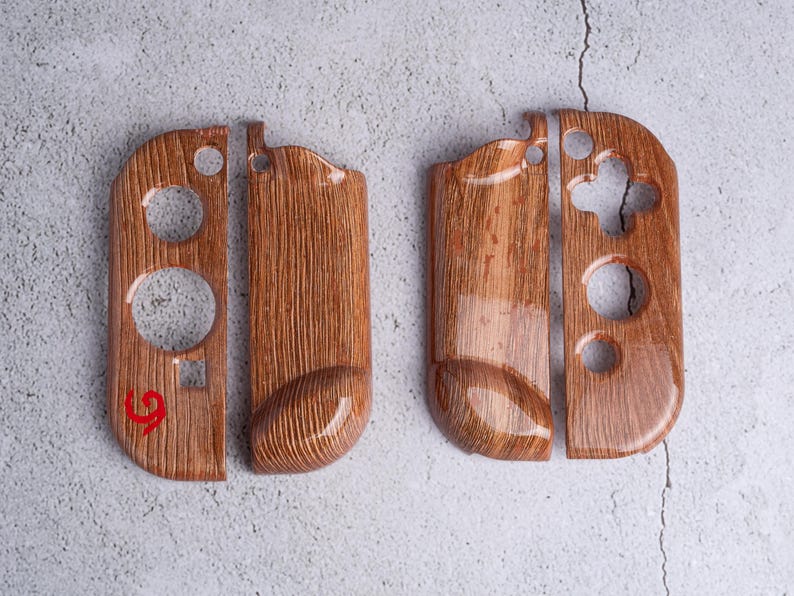 May include: Set of two wooden-look controller shells for a gaming console. The shells are a warm brown color with a wood grain pattern and glossy finish. Each shell has cutouts for buttons and controls.