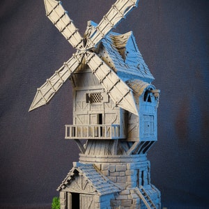 May include: A gray, wooden windmill miniature with a stone base and a small building attached. The windmill has a thatched roof and a working wooden fan.