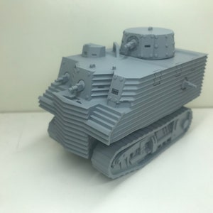 May include: A gray, detailed model of a tank with a turret and tracks. The tank has a textured surface and appears to be made of plastic.