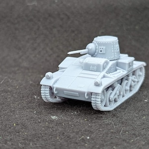 May include: A grey plastic model of a small tank with a turret and a gun barrel. The tank has tracks and wheels.