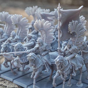 May include: A group of miniature gray-colored cavalry figures on horseback, each with detailed armor and feathered wings. Some figures hold lances and a flag. The figures are mounted on a rectangular base.