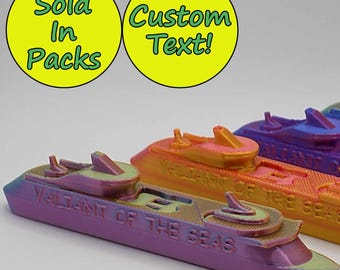 May include: Five miniature cruise ships in various shades of purple, blue, orange, and yellow. The ships are all labeled "Valiant of the Seas".