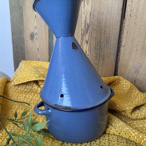 May include: A set of three ceramic mugs with a speckled, matte finish. The mugs are in shades of cream, light gray, and dark gray. Each mug has a simple, minimalist design and a rounded handle.