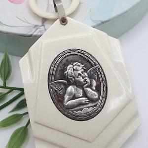 Large religious resin cherub cradle medal, Angelos