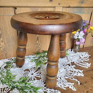 Old wooden stool, milking stool, plant rest, antique stool, rustic
