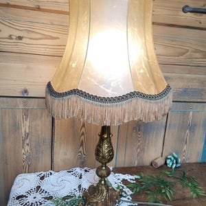 Beautiful antique table lamp with rococo style bronze base and vintage pig bladder shade