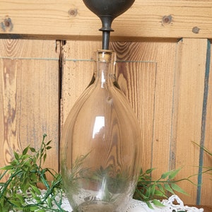 Vintage glass bottle with its cap and its old funnel