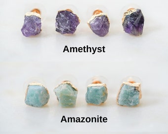 May include: Three sets of earrings featuring different gemstones: amethyst, amazonite, and rose quartz. Each set includes two earrings with gold-plated settings.