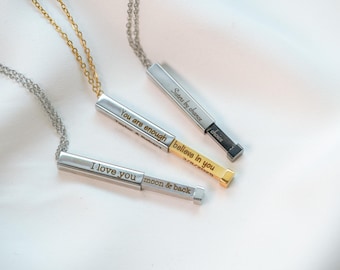 May include: Three rectangular pendant necklaces with engraved text. One silver-toned pendant reads "I love you moon & back." Another reads "You are enough believe in you." The third reads "Sisters by chance choice."