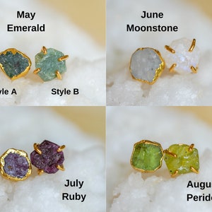 Four different gemstones for four different birth months. Dark green Emerald gemstone for May. White Moonstone gemstone for June. Dark pinkish-red Ruby gemstone for July. Bright green Peridot gemstone for August.
