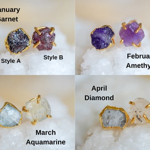 Four different gemstones for four different birth months. Dark red Garnet gemstone for January. Purple Amethyst gemstone for February. Light blue Aquamarine gemstone for March. Clear with a grey undertone Diamond gemstone for April.