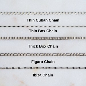 May include: Five different types of silver chains are displayed on a white background. The chains are labeled from top to bottom: Thin Cuban Chain, Thin Box Chain, Thick Box Chain, Figaro Chain, and Ibiza Chain.