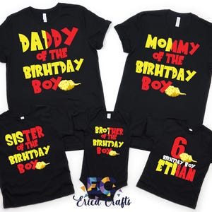 May include: Black t-shirts with colorful text for a birthday celebration. The shirts read "Daddy of the Birthday Boy," "Mommy of the Birthday Boy," "Sister of the Birthday Boy," "Brother of the Birthday Boy," and "6 Birthday Boy Ethan."