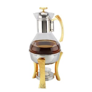 May include: A glass and stainless steel coffee pot with a gold-tone stand. The pot has a clear glass body and a gold-tone lid. The stand has three legs and a round base.