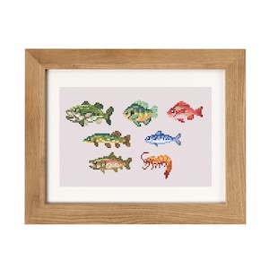 May include: A framed cross-stitch embroidery featuring a variety of fish and a shrimp. The fish are in different colors, including green, blue, red, and orange. The shrimp is orange.