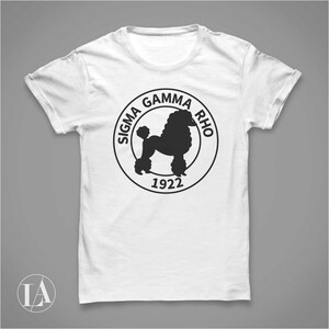 May include: White t-shirt with a black and white circular logo featuring a poodle silhouette and the text "Sigma Gamma Rho 1922".