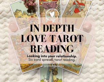 May include: A six-card tarot spread for a love reading. The cards are: Knight of Cups, Queen of Cups, The Lovers, Three of Swords, Six of Swords, and The World. The cards are laid out on a white fuzzy surface with pink flowers and a pink crystal.