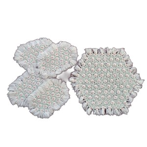 May include: A set of handmade, off-white crochet coasters and a larger placemat. The coasters and placemat have a floral pattern with pink accents and a fringed edge. The items are designed for home decor.