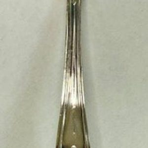 May include: A silver soup ladle with a round bowl and a long handle. The handle features an ornate floral design. The ladle is highly reflective, showing the surrounding environment. This vintage utensil is likely made of stainless steel.