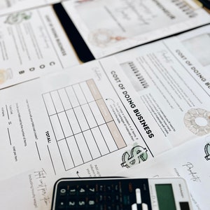 May include: A worksheet titled "Cost of Doing Business" with a table to calculate the cost of making a product. The worksheet includes a dollar sign graphic and a calculator.
