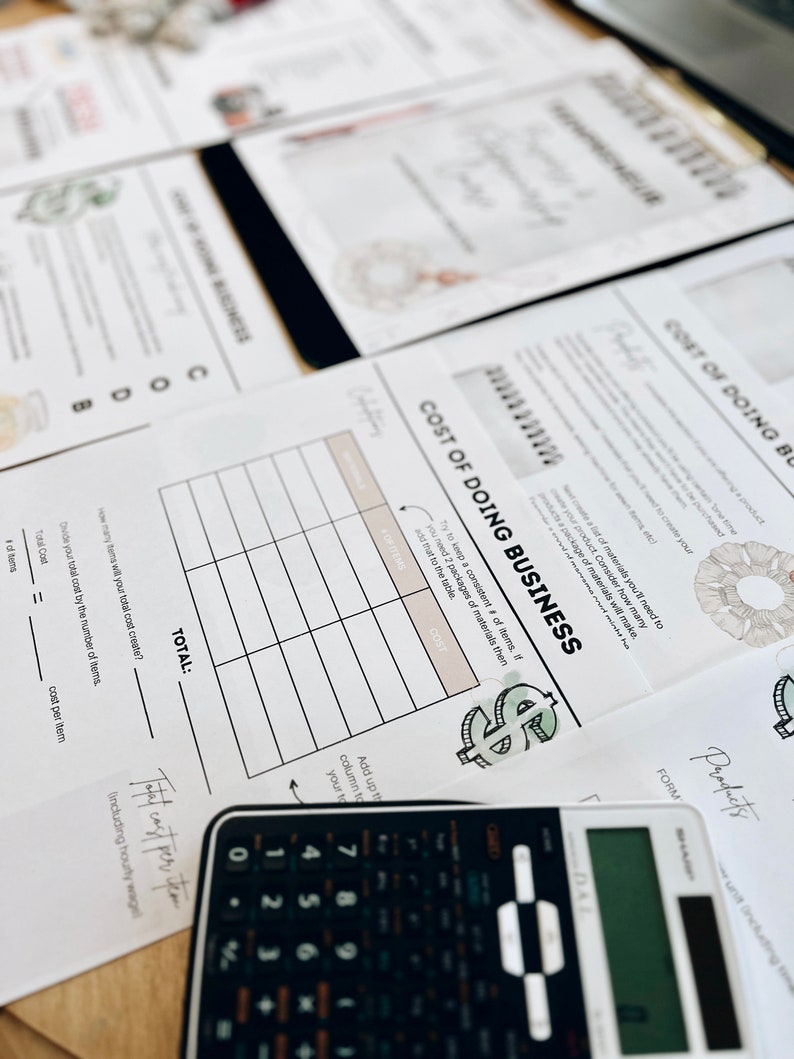 May include: A worksheet titled "Cost of Doing Business" with a table to calculate the cost of making a product. The worksheet includes a dollar sign graphic and a calculator.