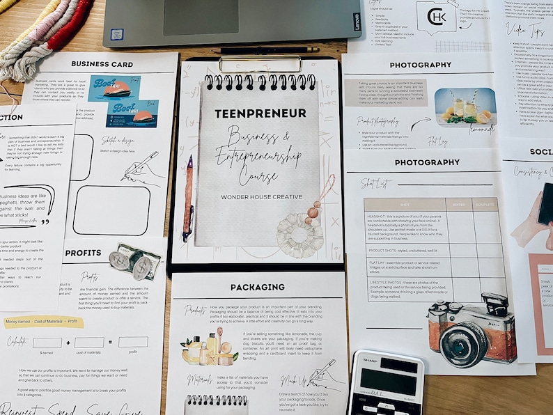 May include: A workbook titled "Teenpreneur: Business & Entrepreneurship Course" by Wonder House Creative. The workbook includes sections on business cards, profits, packaging, and photography. The pages are filled with handwritten notes and sketches.