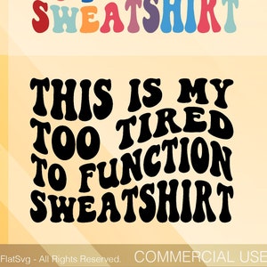 May include: Four variations of a graphic design featuring the text "This is my too tired to function sweatshirt" in a retro, wavy font. The designs are in red, rainbow, white, and black.