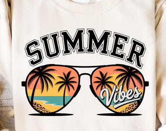 May include: A cream coloured sweatshirt with the text "SUMMER VIBES" in black lettering. The text is above a pair of sunglasses with a sunset and palm trees reflected in the lenses.