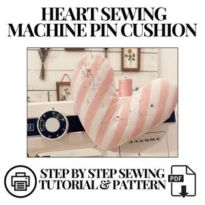 May include: A heart-shaped pin cushion with pink and white stripes, filled with pins, rests on a sewing machine. The text "HEART SEWING MACHINE PIN CUSHION" is at the top. The text "STEP BY STEP SEWING TUTORIAL & PATTERN" is at the bottom.