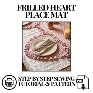 May include: A heart-shaped place mat with a frilled edge, set on a table with a gingham tablecloth. A white plate with cutlery and a napkin is on the mat. The text "FRILLED HEART PLACE MAT" is at the top, with "STEP BY STEP SEWING TUTORIAL & PATTERN" below.