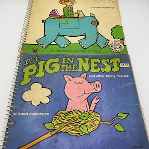 May include: Two vintage children's activity books with colorful illustrations. The top book features a blue elephant with a person driving it. The bottom book features a pink pig in a nest. Both books have the title "Merry Mix-Up Book" and the text "Mix and Match 100 Funny Pictures!"